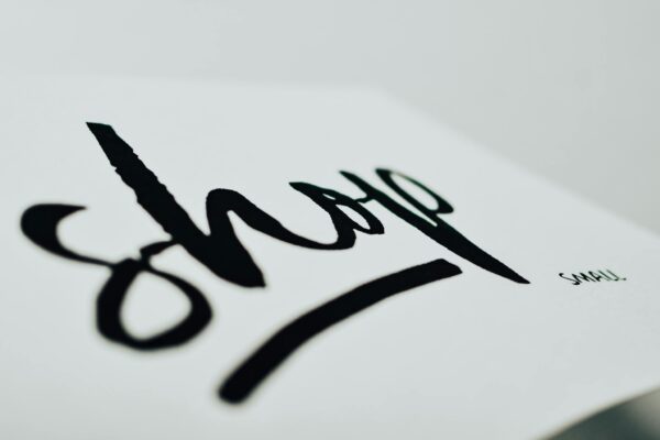 Close-up of a handwritten sign promoting support for small businesses.
