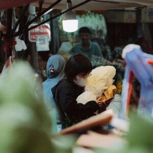 Shoppers exploring a bustling street market filled with diverse goods and vibrant atmosphere.