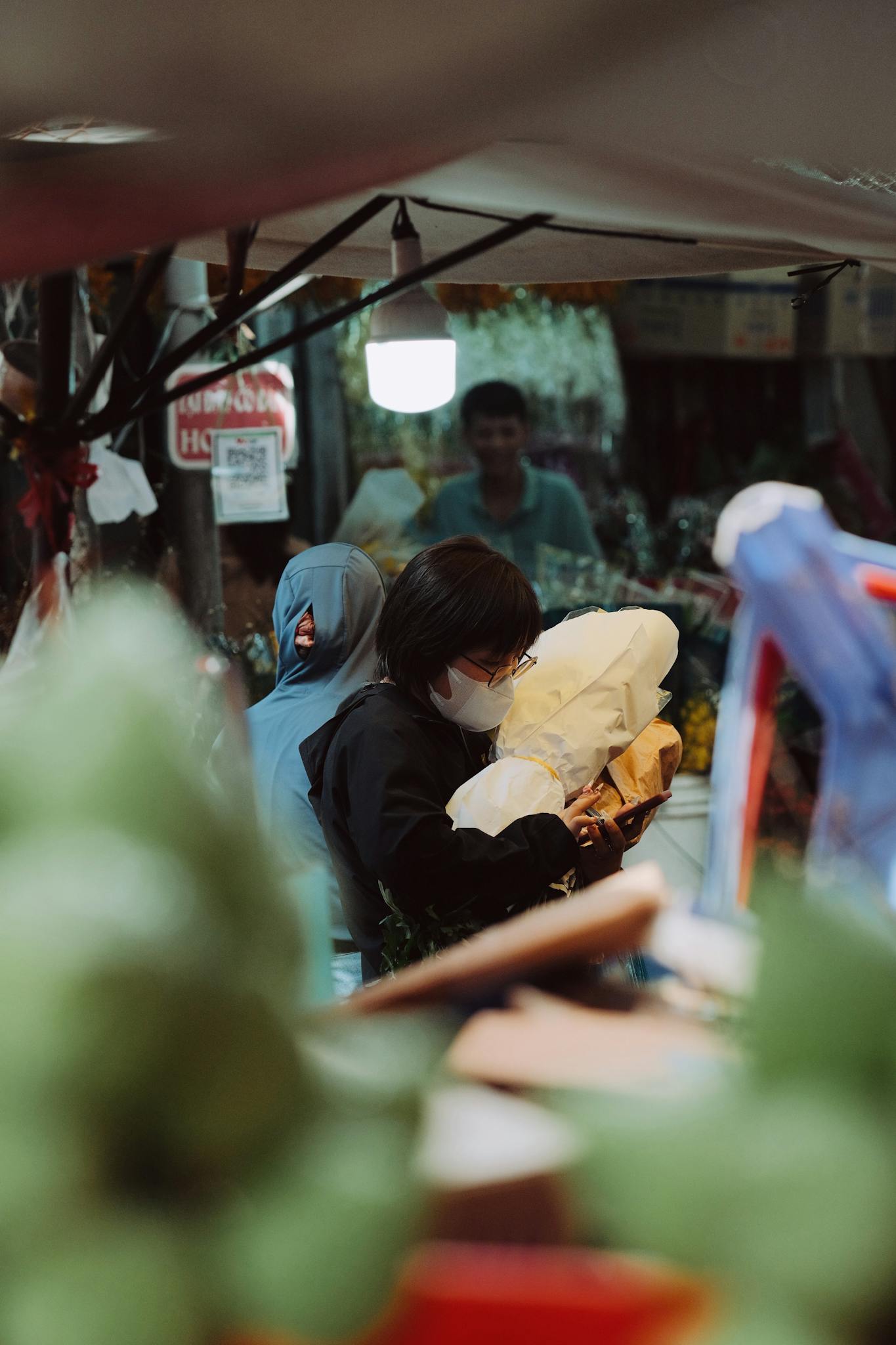 Shoppers exploring a bustling street market filled with diverse goods and vibrant atmosphere.