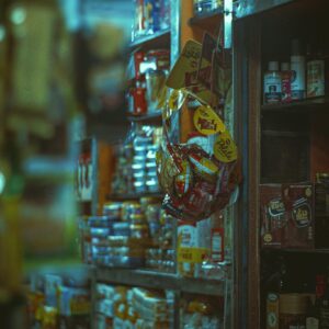 Vibrant interior of a small shop with diverse snacks and goods on shelves.
