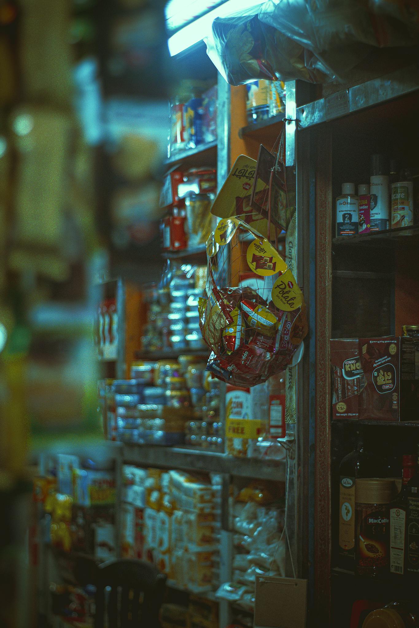 Vibrant interior of a small shop with diverse snacks and goods on shelves.